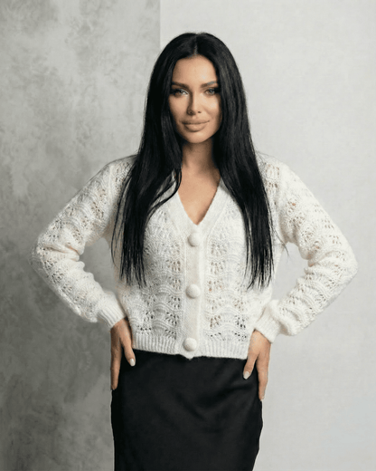 Serena Cardigan by Slimona, a lace knit V-neck button front cardigan in white worn by a model.