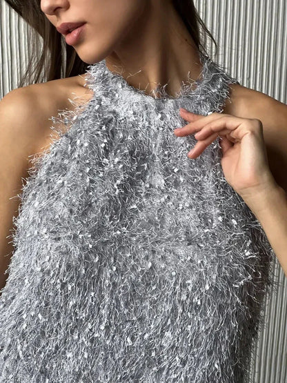Close-up of a model in a silver halter mini dress with a fringe texture, perfect for summer and party occasions.