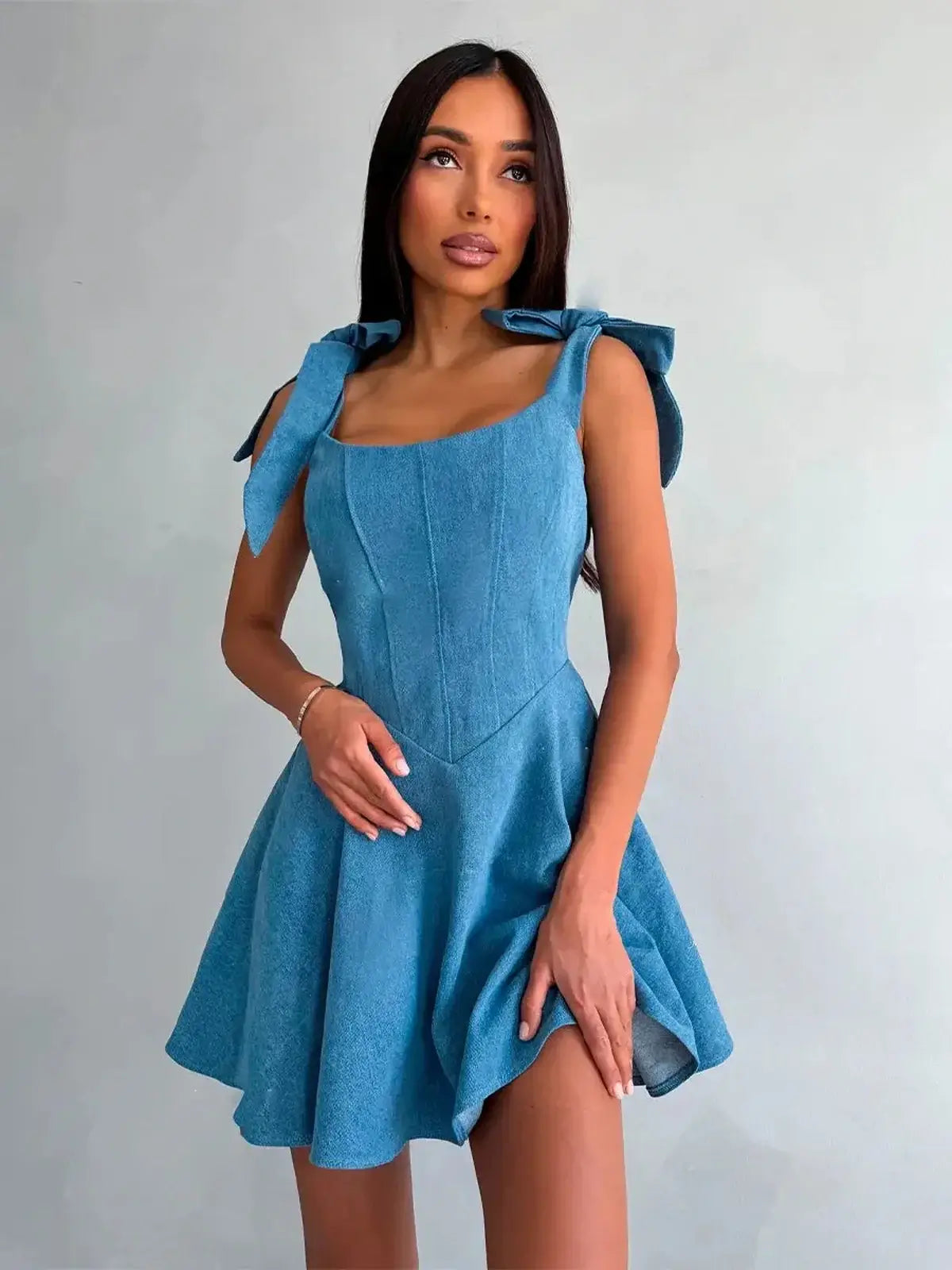Sky Bow Corset in soft blue, featuring bow straps and a flared mini skirt, perfect for summer or wedding guest dresses.