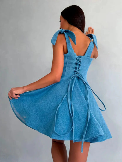 Sky Bow Corset dress in soft blue, featuring a flared mini skirt and tie straps, perfect for summer parties and weddings.