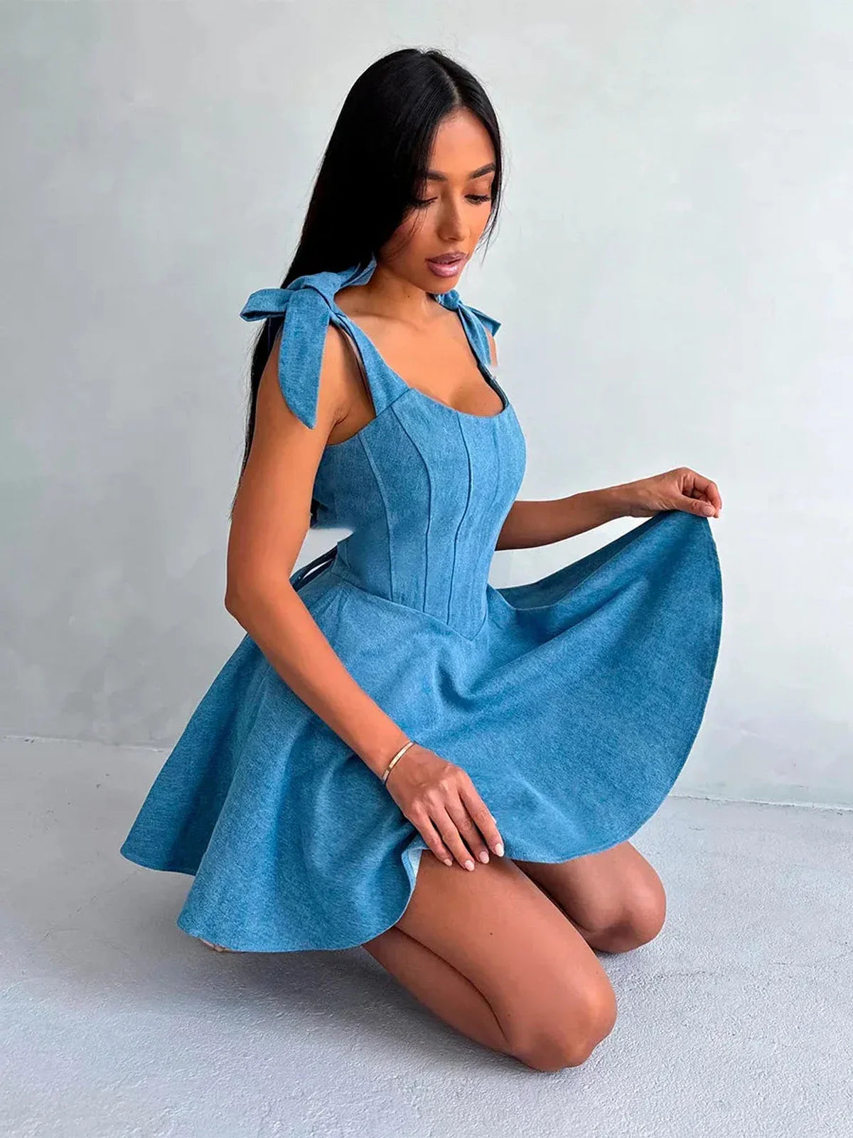 Soft blue corset dress with bow straps, perfect for summer parties and wedding guest outfits.