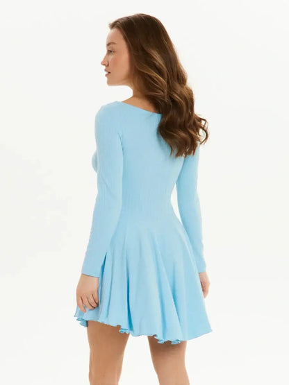 Model showcasing a light blue mini dress with long sleeves and a flared silhouette, perfect for summer occasions.