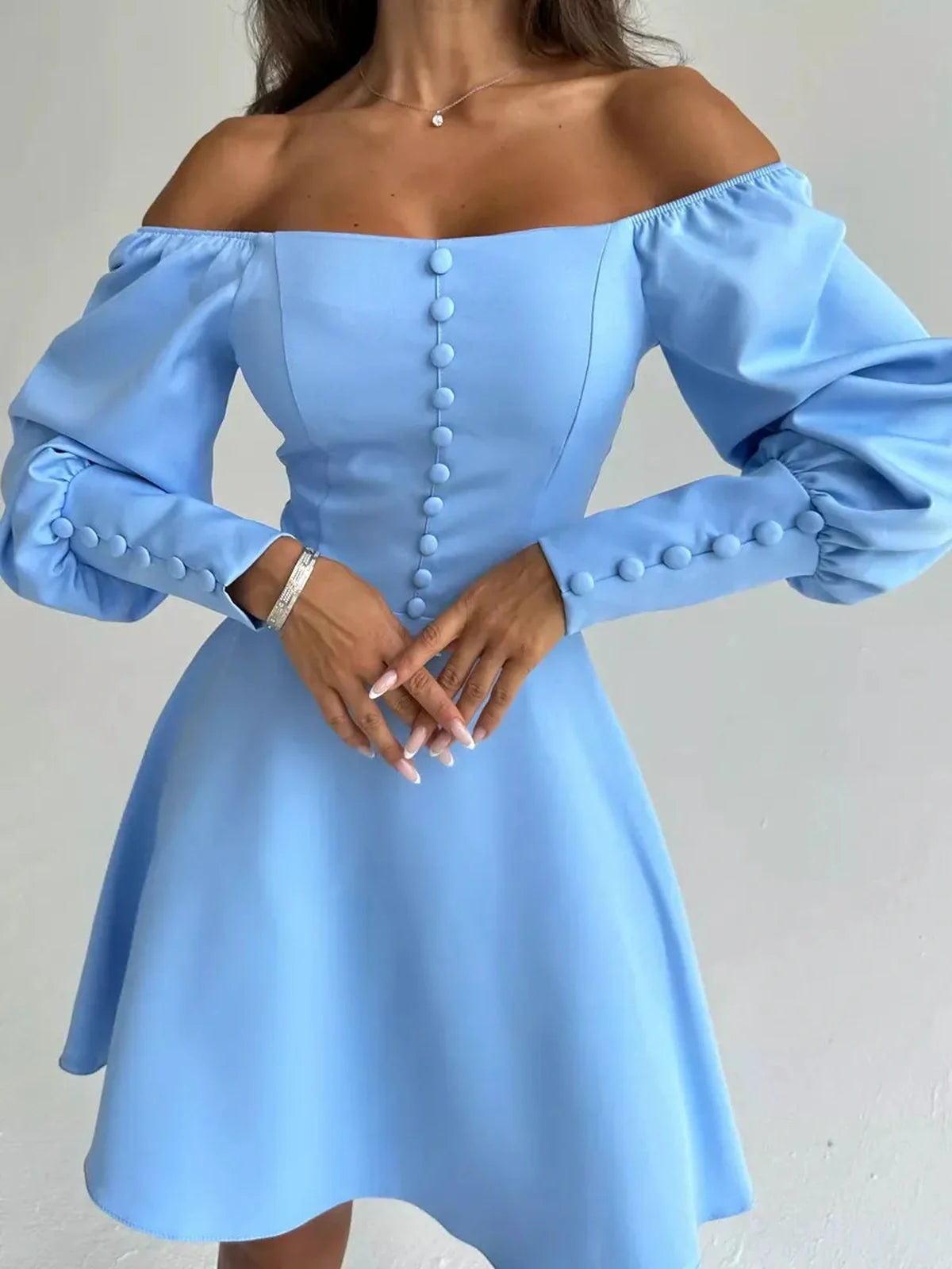Skyline Muse Mini Dress in sky blue with off-the-shoulder neckline and puffed sleeves, perfect for summer occasions.