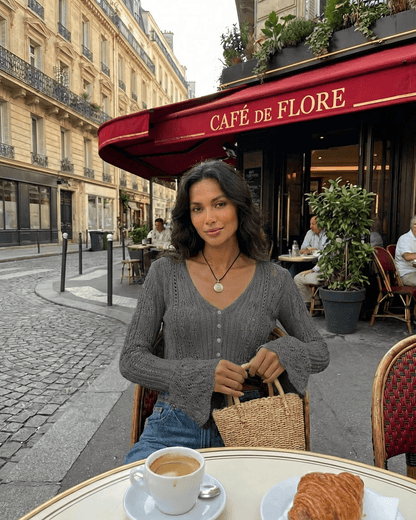 Model wearing Slate Cardigan from Slimona, enjoying coffee at Café de Flore with a stylish, relaxed ambiance.