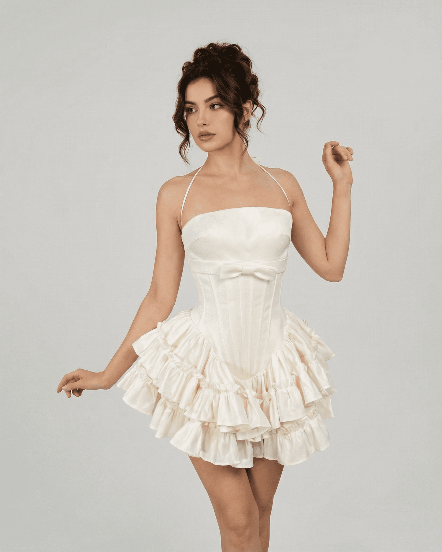 Celeste Mini Dress by Slimona, a soft white corset-inspired tiered dress featuring a sculpted bodice and halter straps.