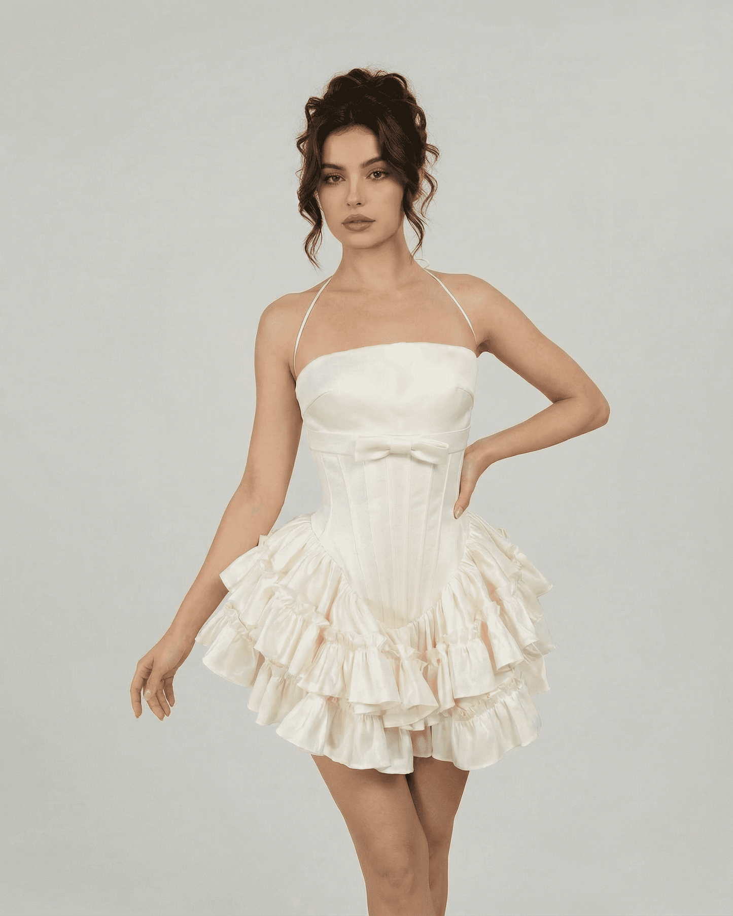 Celeste Mini Dress by Slimona, a structured tiered mini dress in soft white with halter straps.