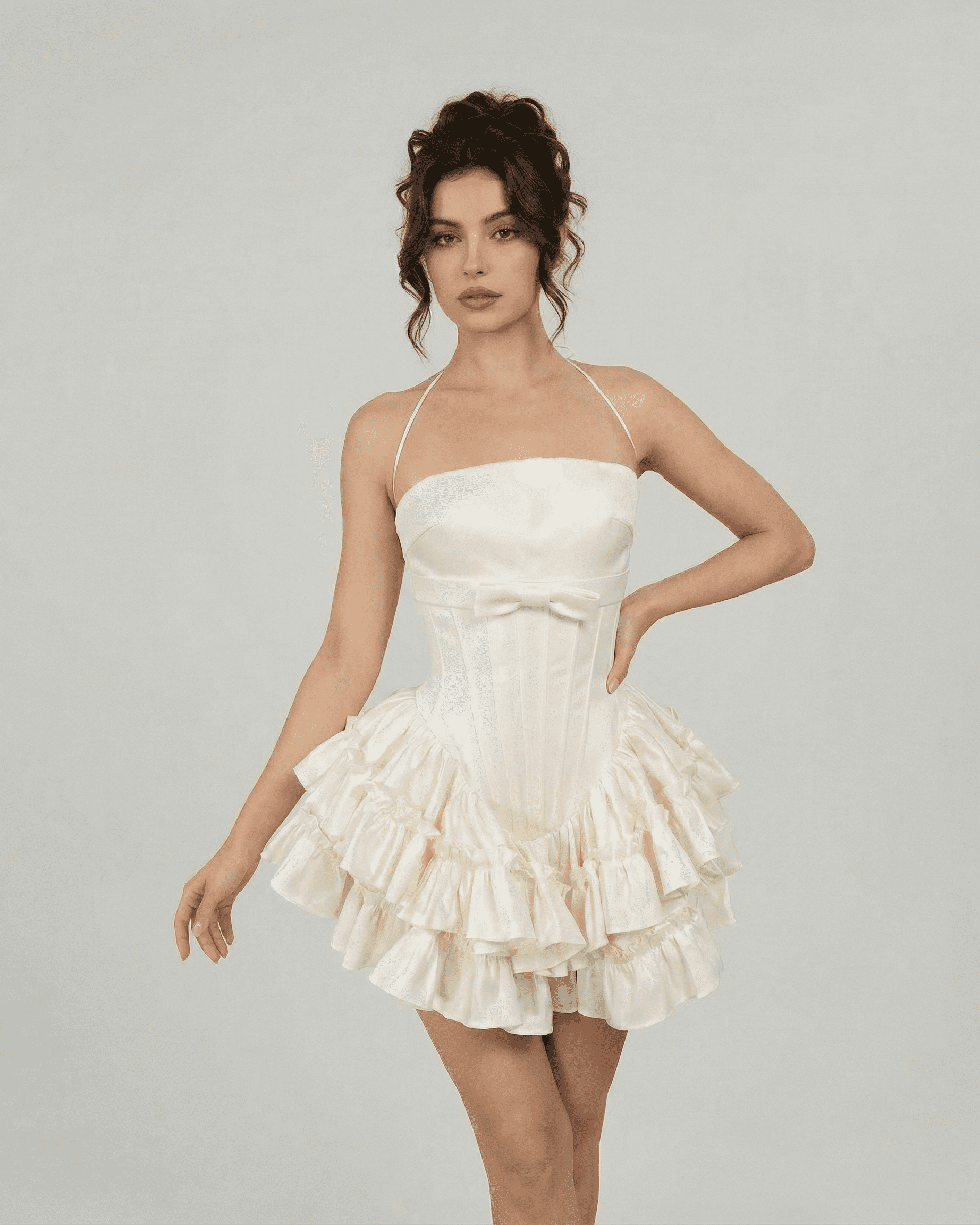 Celeste Mini Dress by Slimona, a structured tiered mini dress in soft white with halter straps.