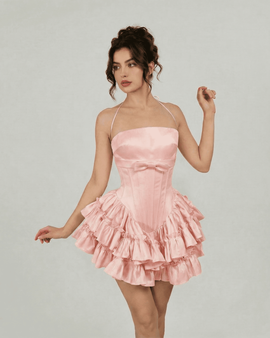Rosé Mini Dress by Slimona in soft blush pink with corset-inspired bodice and tiered ruffles.