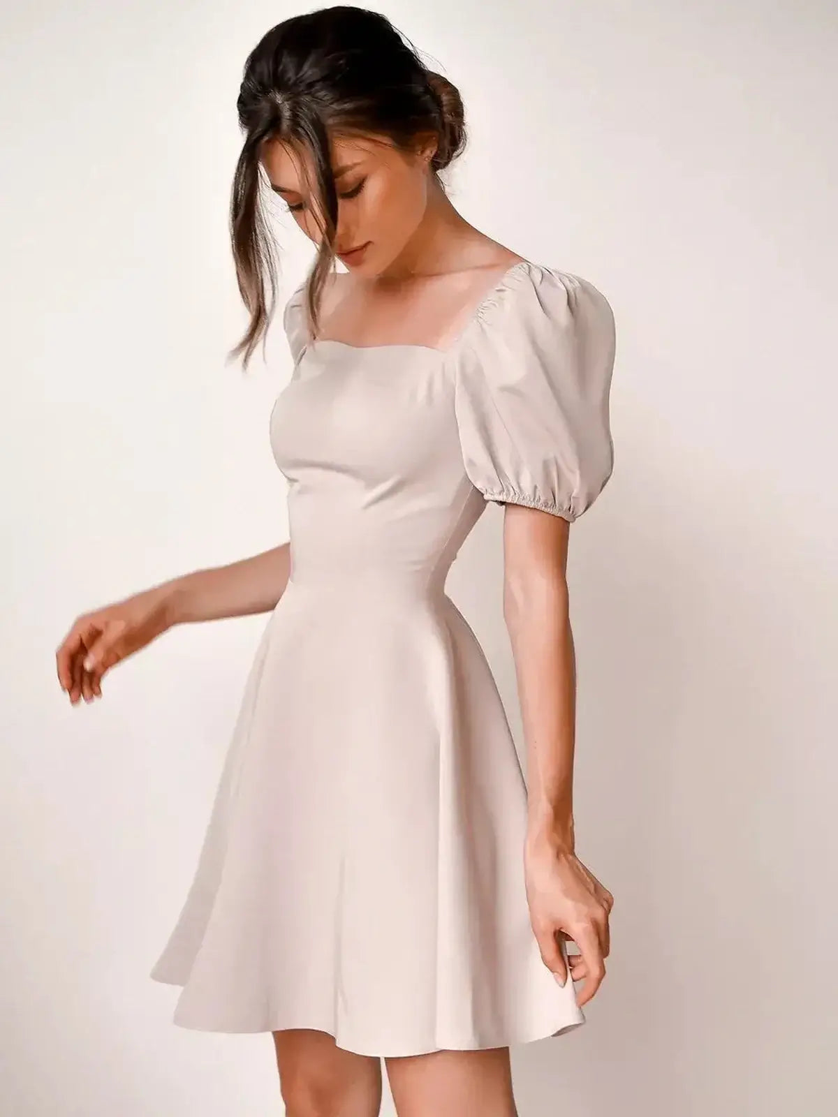 Beige mini dress with puff sleeves and square neckline, perfect for summer, weddings, and formal events.