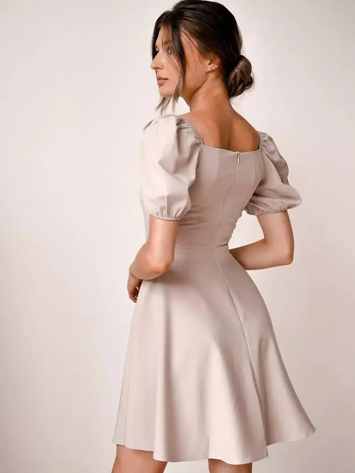 Elegant beige mini dress with puff sleeves and square neckline, perfect for wedding guests and summer events.