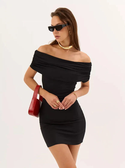 Chic woman in a black bodycon mini dress with off-the-shoulder design and sunglasses, perfect for summer parties.
