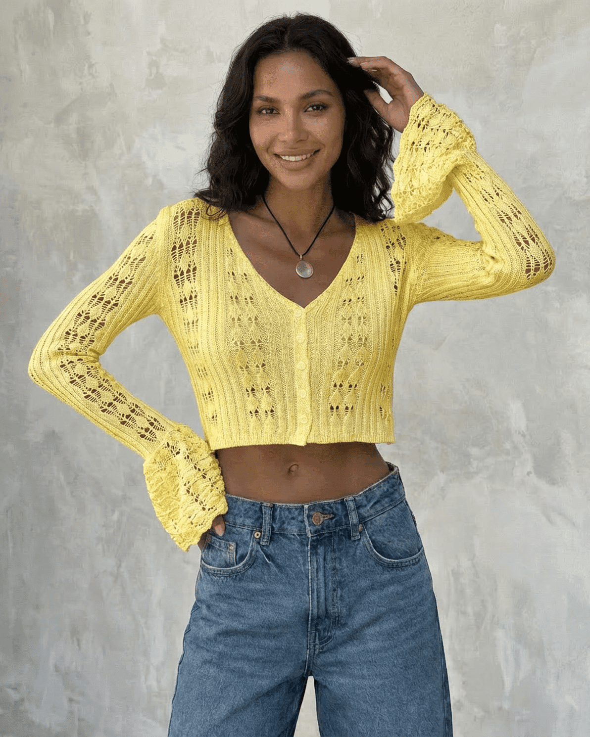 Solana Cardigan by Slimona in bright yellow, featuring flare sleeves and intricate hollow-out detailing.