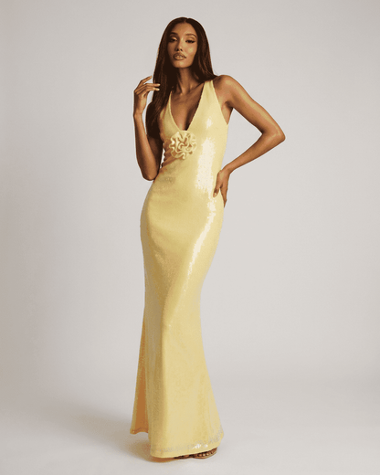 Solara Maxi Dress by Slimona, featuring a backless V-neck and floral sequin detail in luminous yellow.