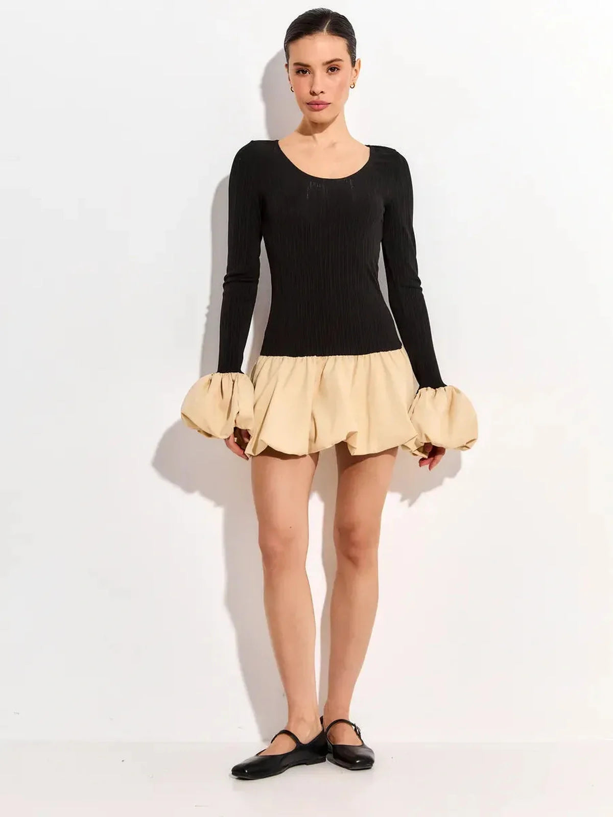 Black long sleeve mini dress with beige bubble skirt, perfect for summer parties or formal events.