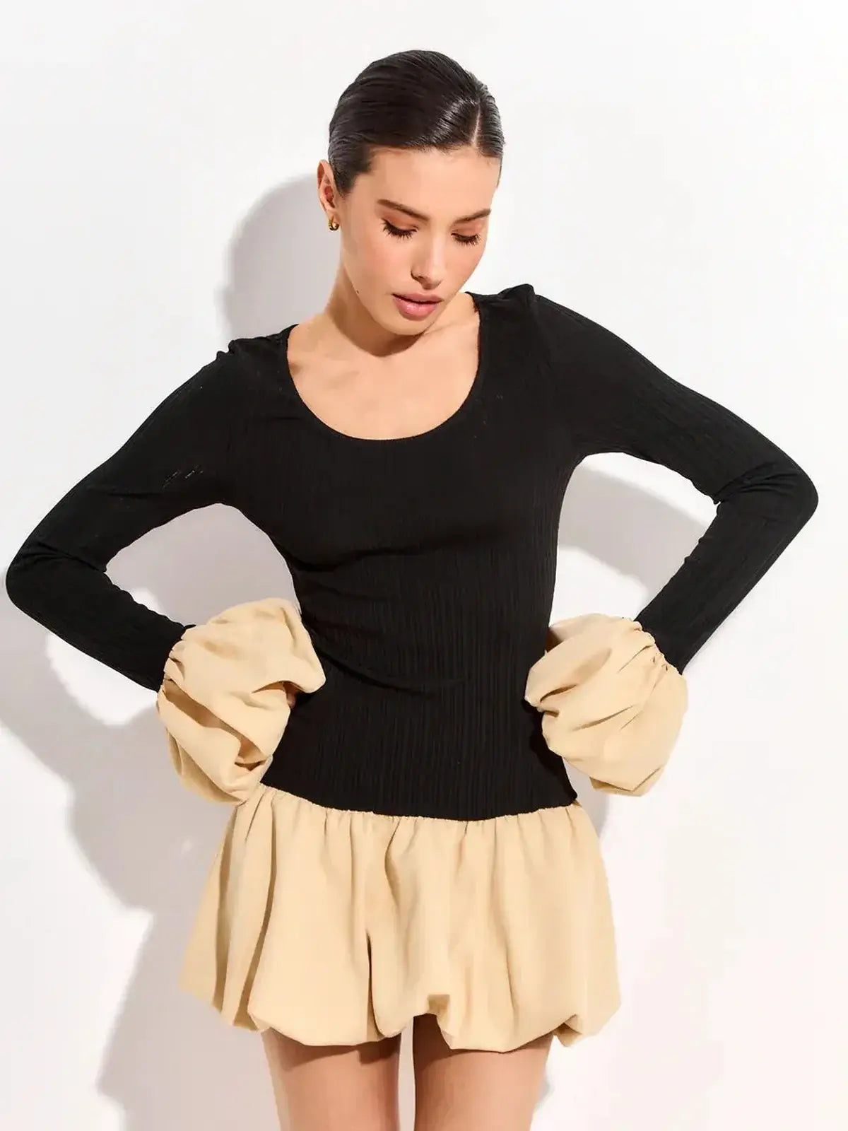 Elegant black and beige split mini dress with puff sleeves and a fitted waist, perfect for summer parties.