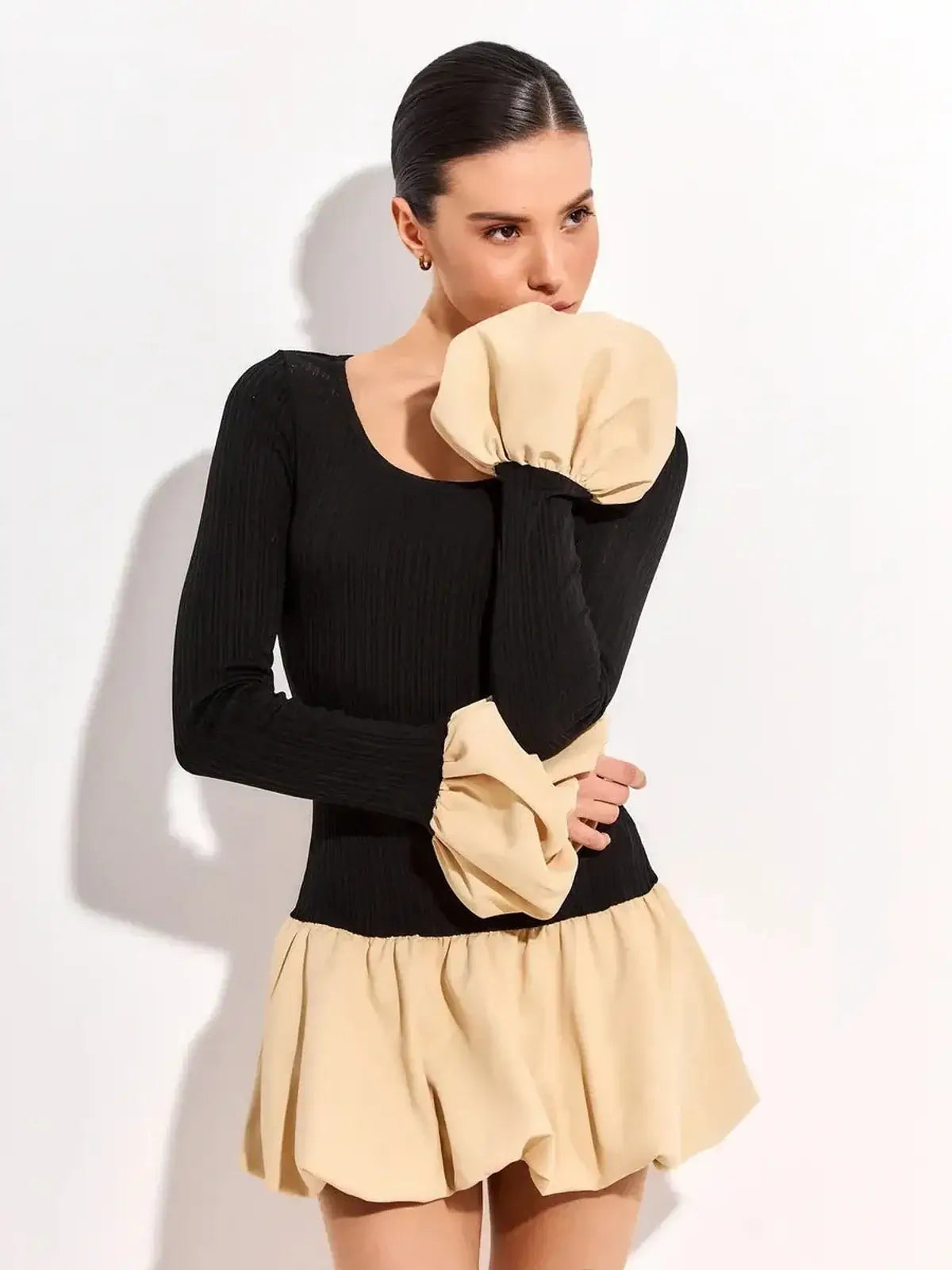Black and beige two-tone Split Statement mini dress with ribbed long sleeves and voluminous skirt.