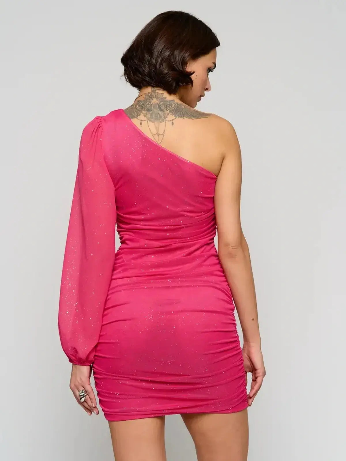 Back view of Starlit One-Shoulder pink mini dress with sheer long sleeve and ruched body for evening or cocktail occasions.