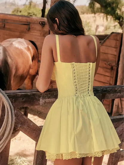 Woman in a yellow Sunlace Corset mini dress with lace-up back, perfect for summer gatherings and casual outings.