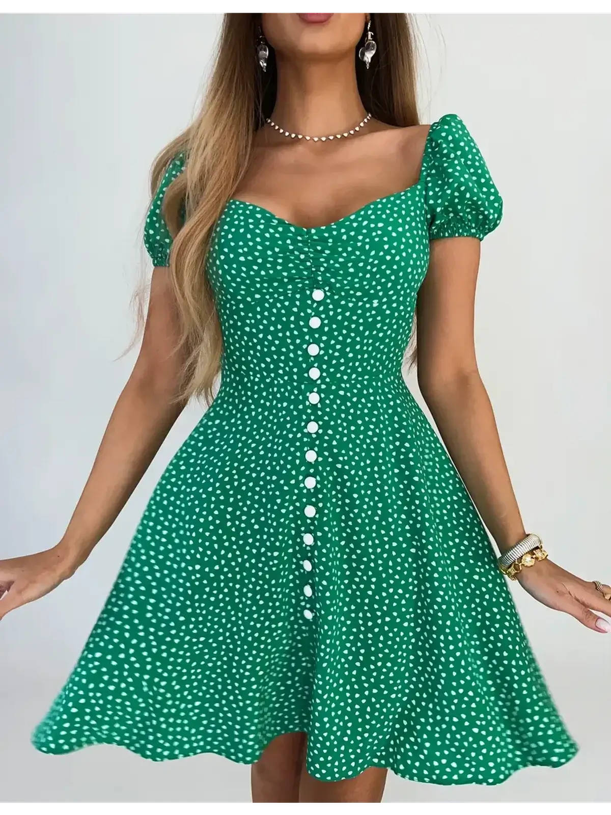 Green sweetheart charm mini dress with puff sleeves and button detail, perfect for summer parties and casual outings.