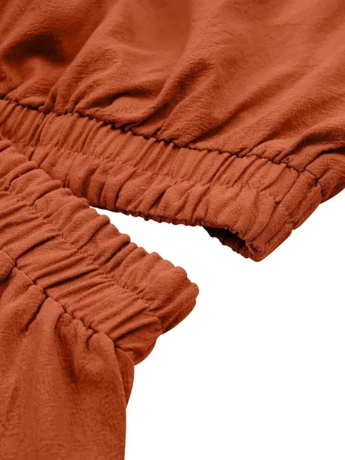 Close-up of the gathered elastic waist detail on the Terracotta Flare Mini Dress.