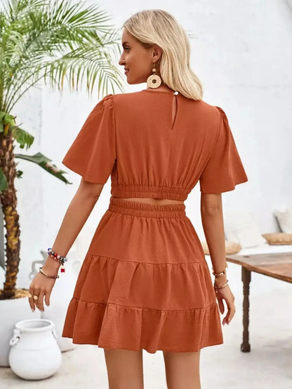 Terracotta flare mini dress featuring flutter sleeves and a gathered waist, perfect for summer outings and casual events.