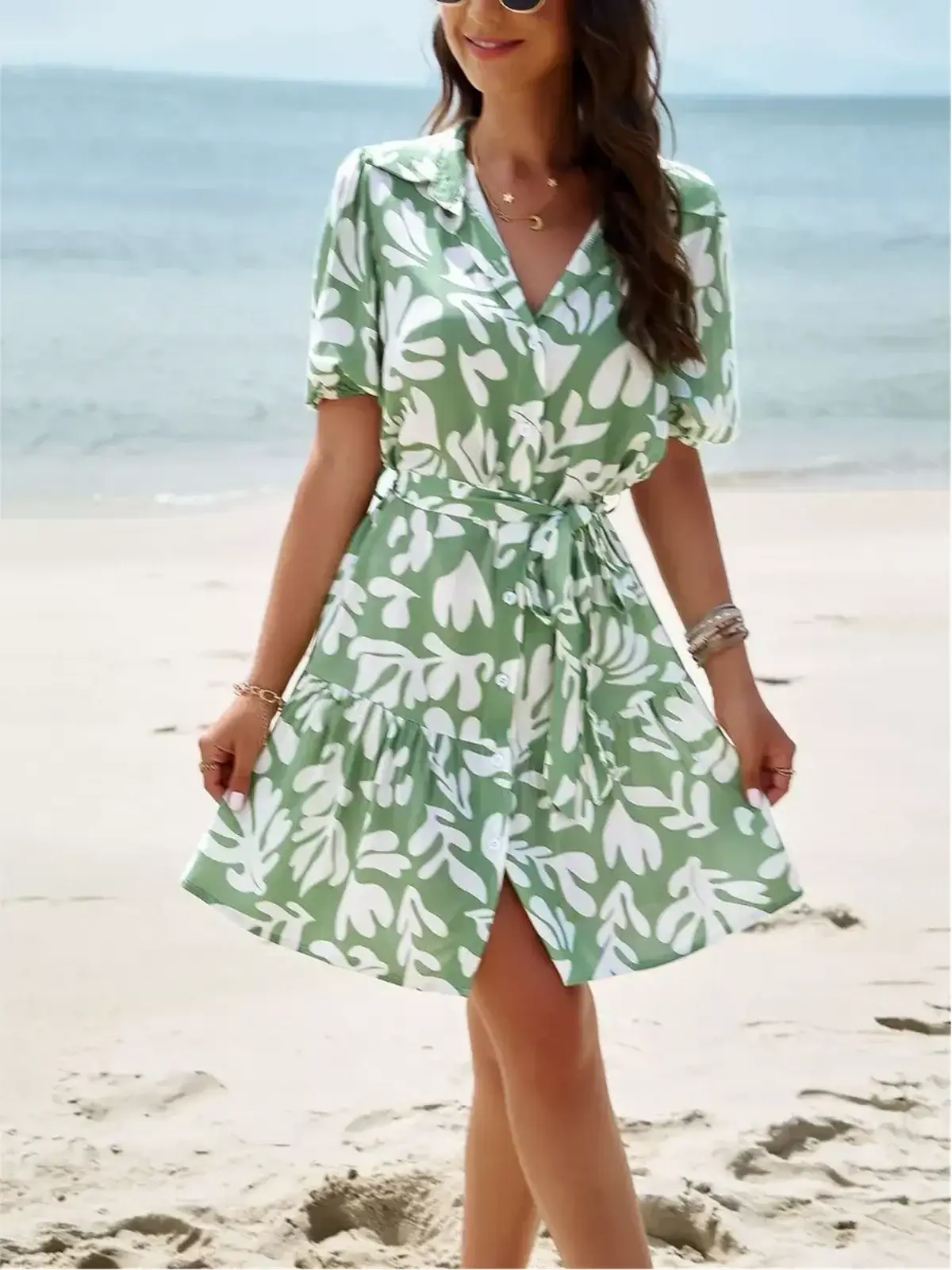 Tropica Breeze Mini Dress in soft green tropical print, perfect for summer weddings and casual outings.
