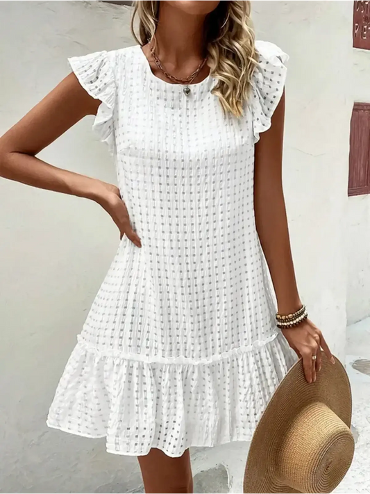 White mini dress with ruffled sleeves, perfect for casual summer outings and beach days.