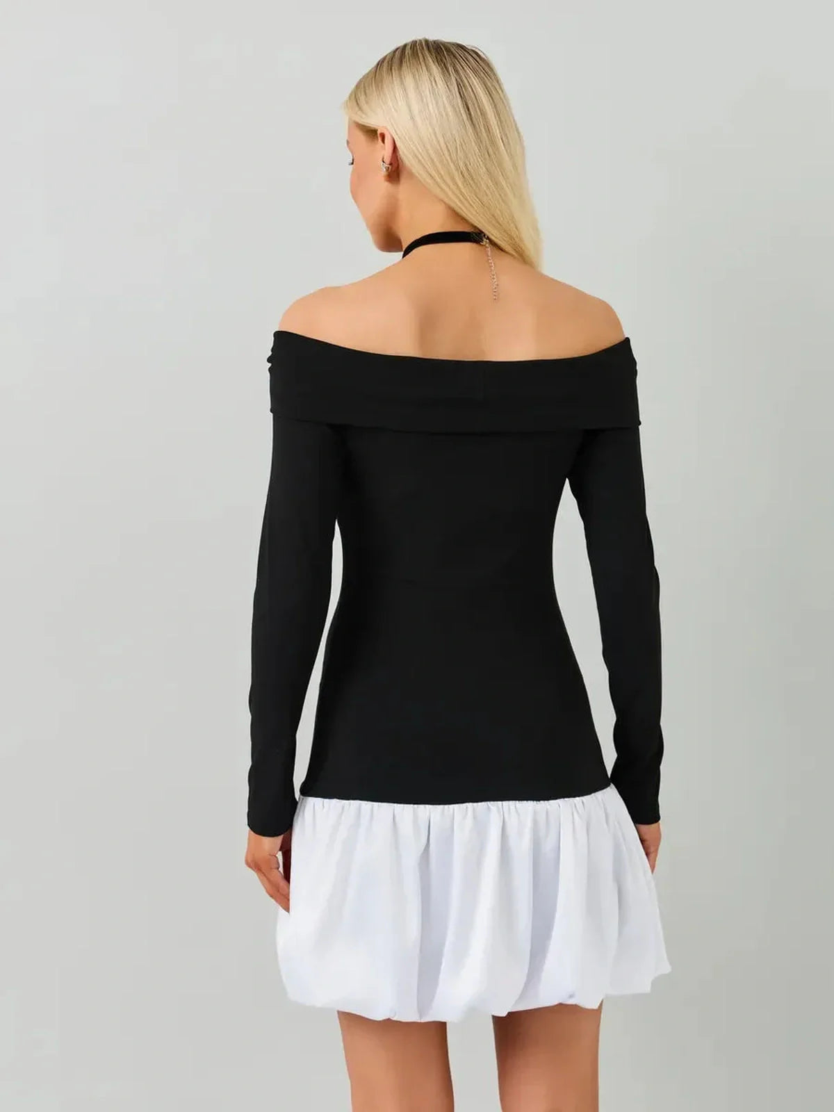 Black and white off-the-shoulder mini dress featuring long sleeves and a bubble skirt, perfect for parties and summer events.