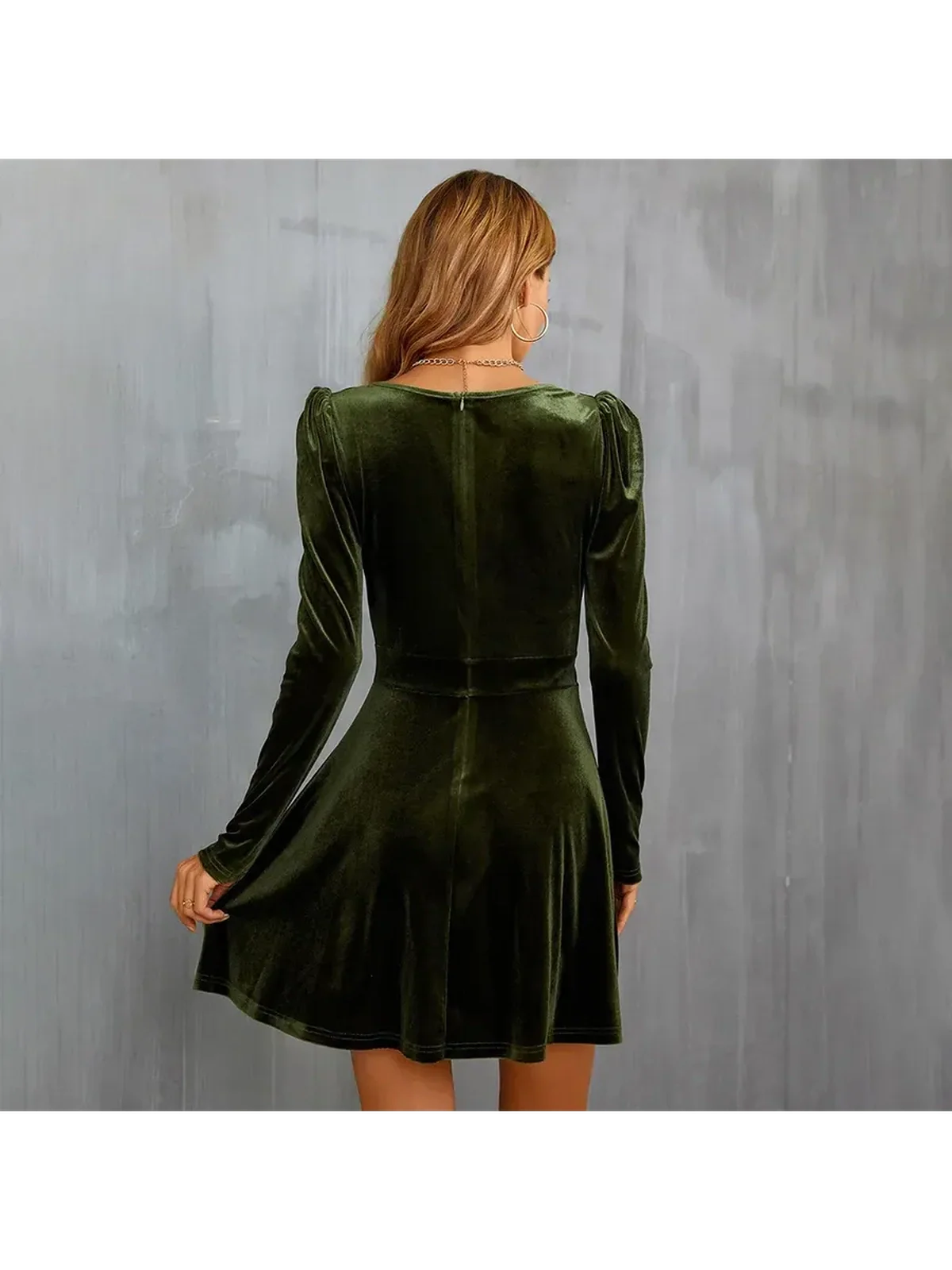 Back view of a green velvet mini dress featuring long sleeves and a flared skirt, perfect for parties.