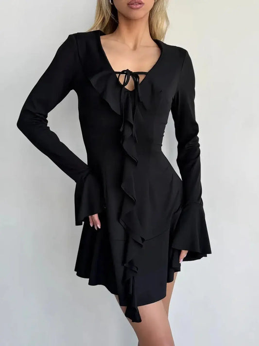Black long sleeve mini dress with V-neck, ruffles, and tie-front accent, perfect for parties or weddings.