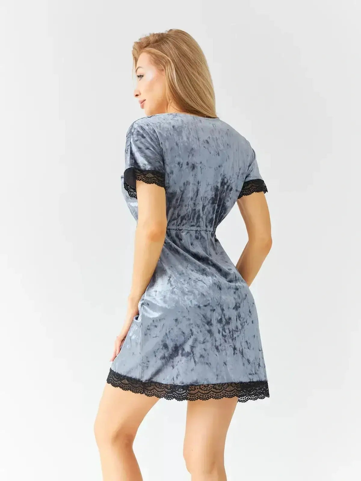 Elegant light blue velvet mini dress with black lace trim, perfect for weddings and parties. Flattering wrap-style fit.