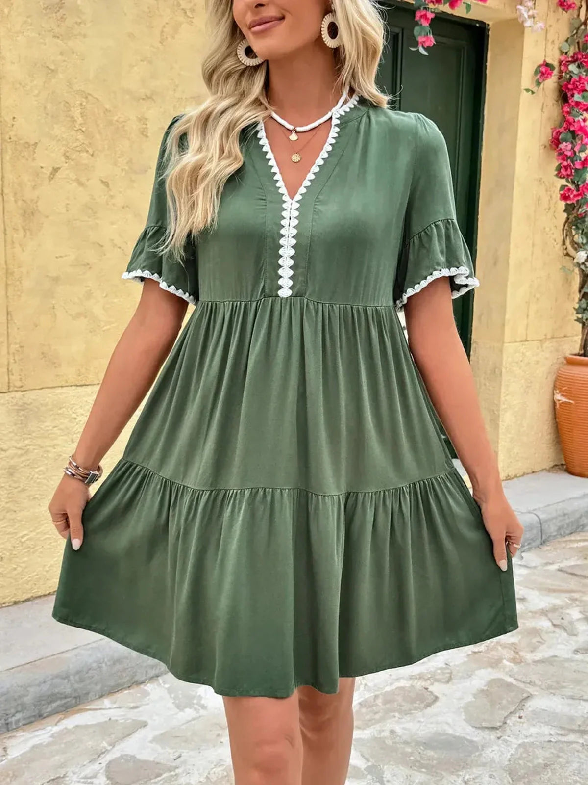 Green Veranda Bloom Mini Dress with V-neckline and ruffle sleeves, perfect for summer parties and weddings.