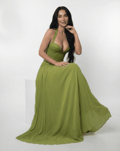 Model wearing Slimona Verdant Maxi Dress featuring lace bodice and pleated skirt in olive green.