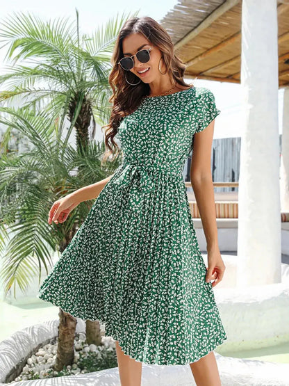 Model in a green floral midi dress with flutter sleeves, perfect for summer weddings and casual outings.