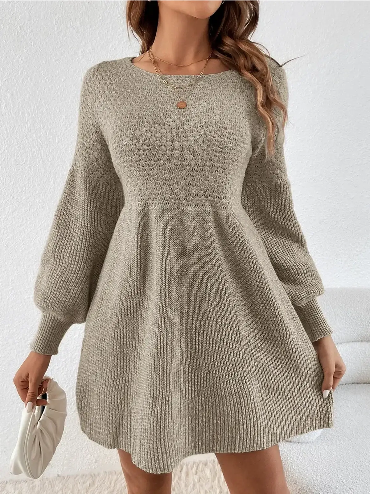 Chic long sleeve knit mini dress in neutral shade, perfect for cozy occasions and fall fashion.