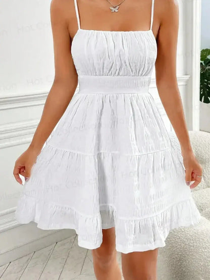 Whisper Charm Mini Dress in white, featuring spaghetti straps and a tiered skirt, perfect for summer outings and special occasions.