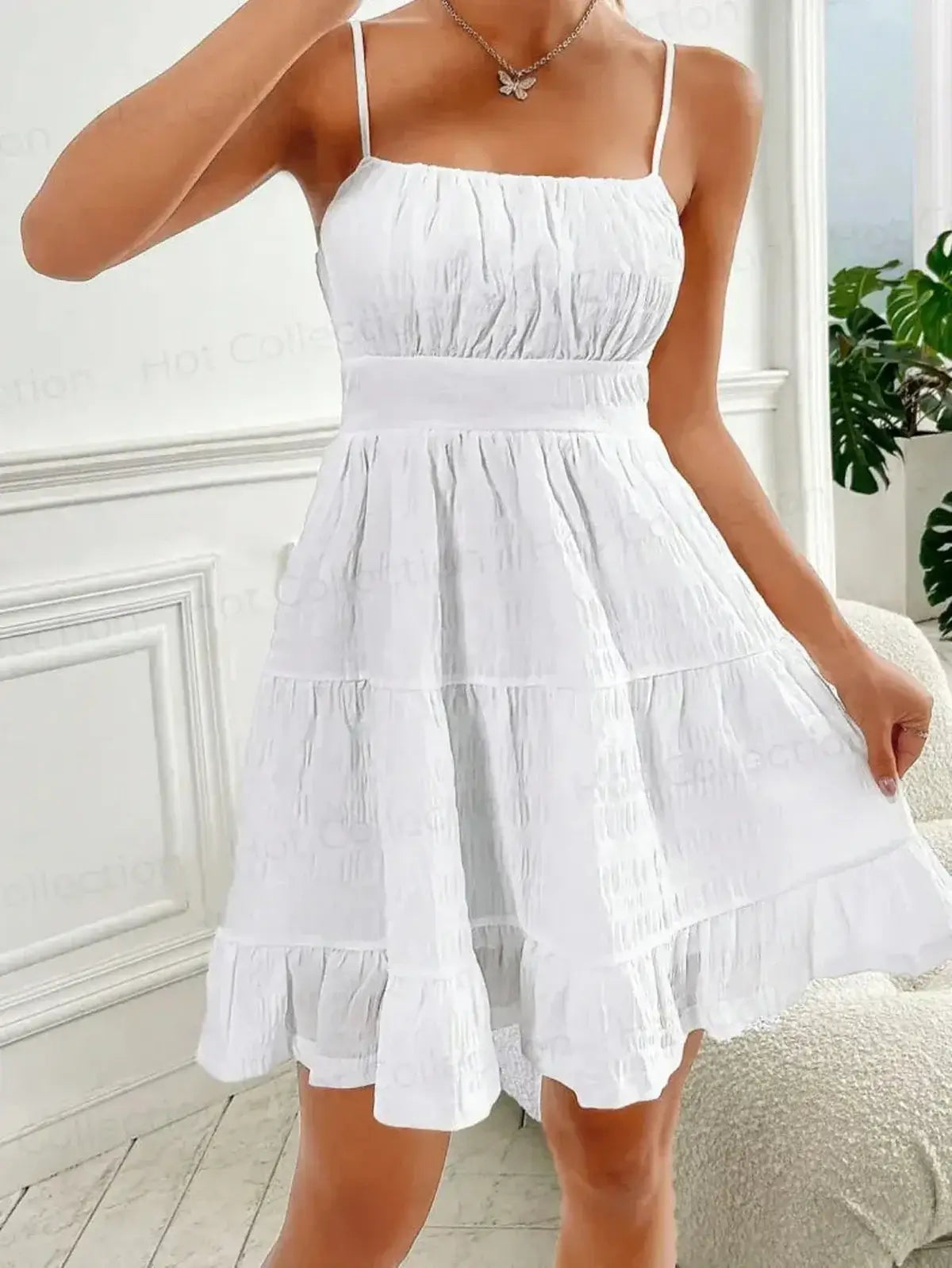 White Whisper Charm Mini Dress with spaghetti straps and tiered skirt, perfect for summer outings and weddings.