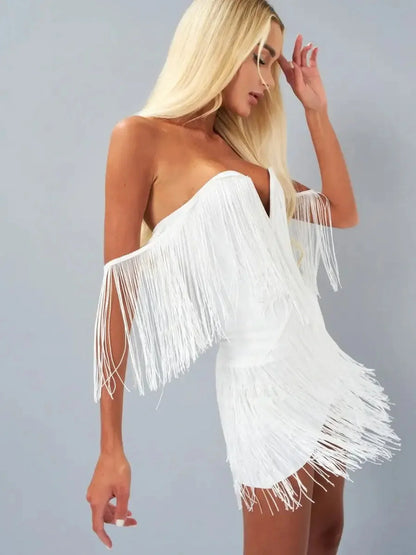 Model showcasing the Fringe Fantasy white mini dress with cascading fringe and off-the-shoulder design.