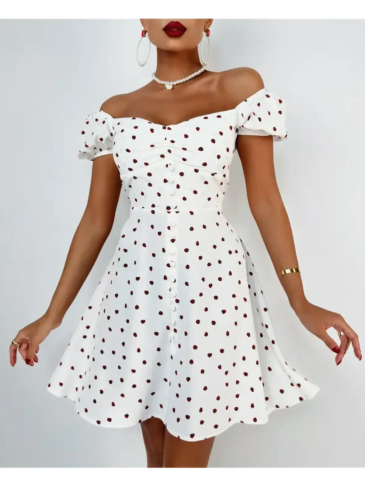 Charming white mini dress with polka dots, off-shoulder design, and button detailing, perfect for summer parties.