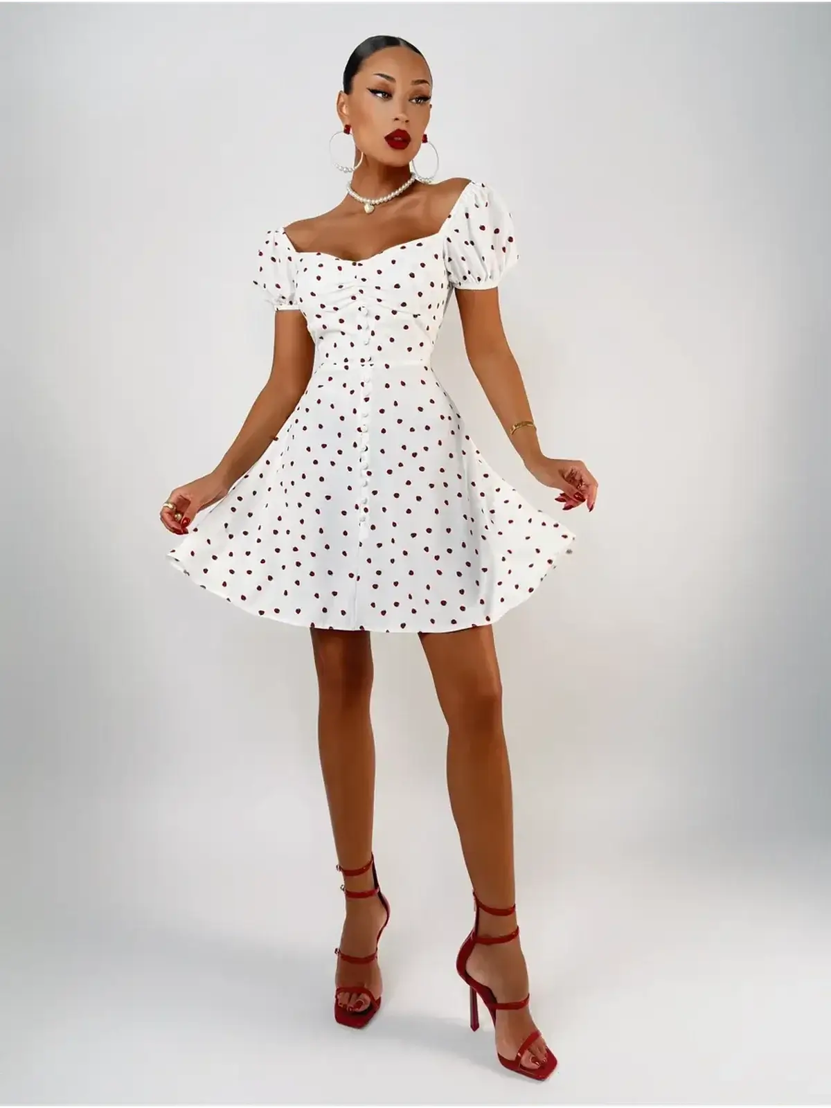 White mini dress with puff sleeves and polka dots, perfect for summer parties and casual outings.