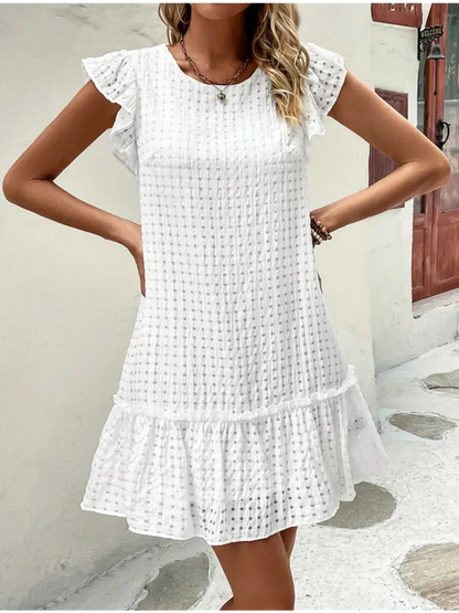White cotton mini dress featuring ruffled sleeves and a tiered hem, perfect for summer outings or casual events.