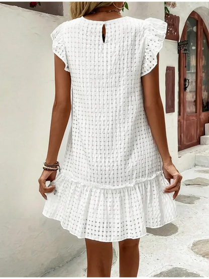 Back view of a white summer dress with ruffled sleeves and hem, perfect for casual occasions or beach outings.