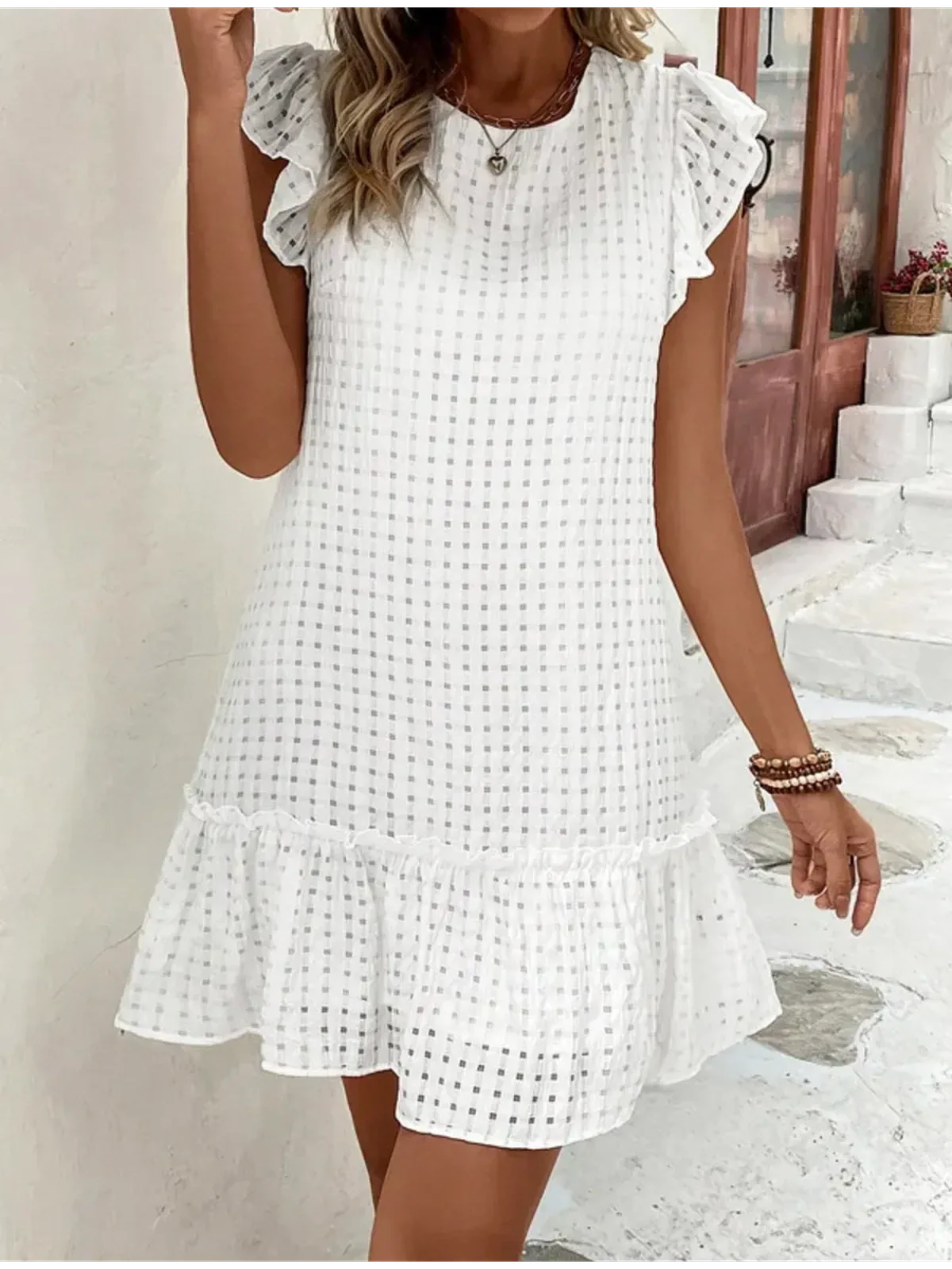 White tulle above knee mini dress with ruffle sleeves perfect for summer, casual outings or wedding guest attire.