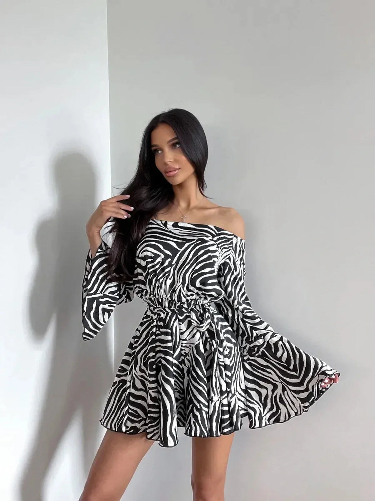Zebra Daze Mini Dress featuring off-shoulder neckline and flared sleeves, perfect summer dress for parties or weddings.